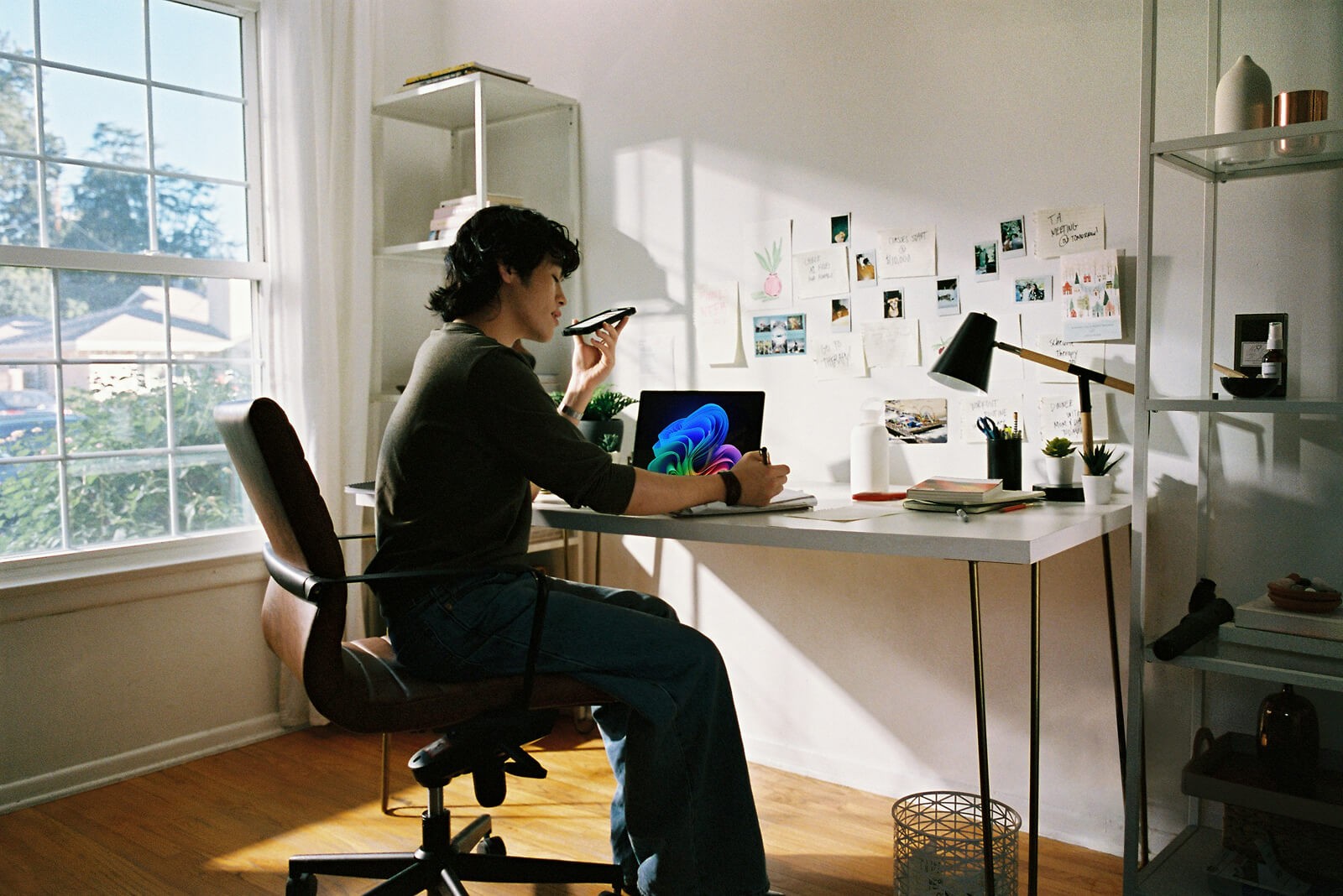 Person working at a desk in a sunlit home office