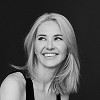 Black and white headshot of a smiling woman